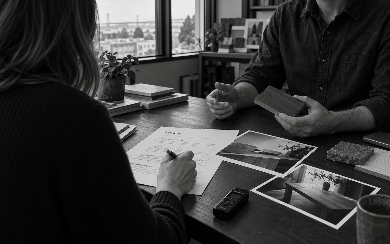 A writer interviewing a business expert and checking a service-page draft.